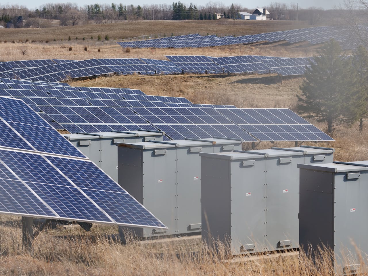 Expansive solar panel field in a rural area harnessing solar energy. Sustainable and renewable energy source.